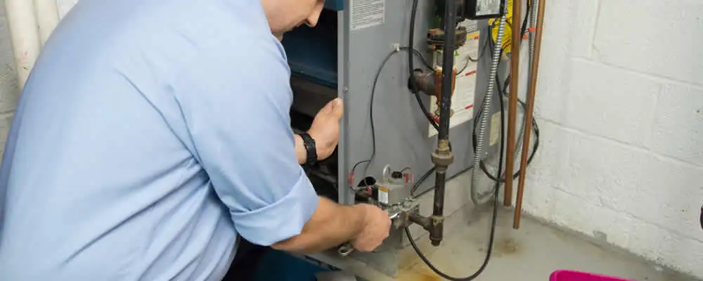 Furnace repair technician inspecting and servicing a home heating system in Saint Petersburg, FL