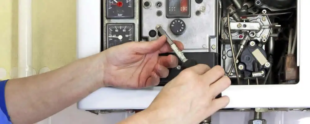 Heating repair technician adjusting boiler controls and components in Saint Petersburg, FL