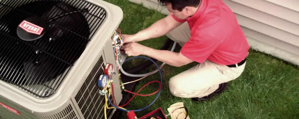 HVAC technician servicing an outdoor air conditioner unit in Saint Petersburg, FL